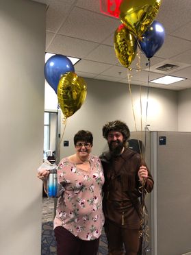 WVU Mountaineer with woman holding balloons