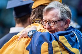 WVU President Gordon Gee hugs graduates during the Eberly College of Arts and Sciences Undergraduate Commencement at the Coliseum May 12th, 2019. Photo Brian Persinger