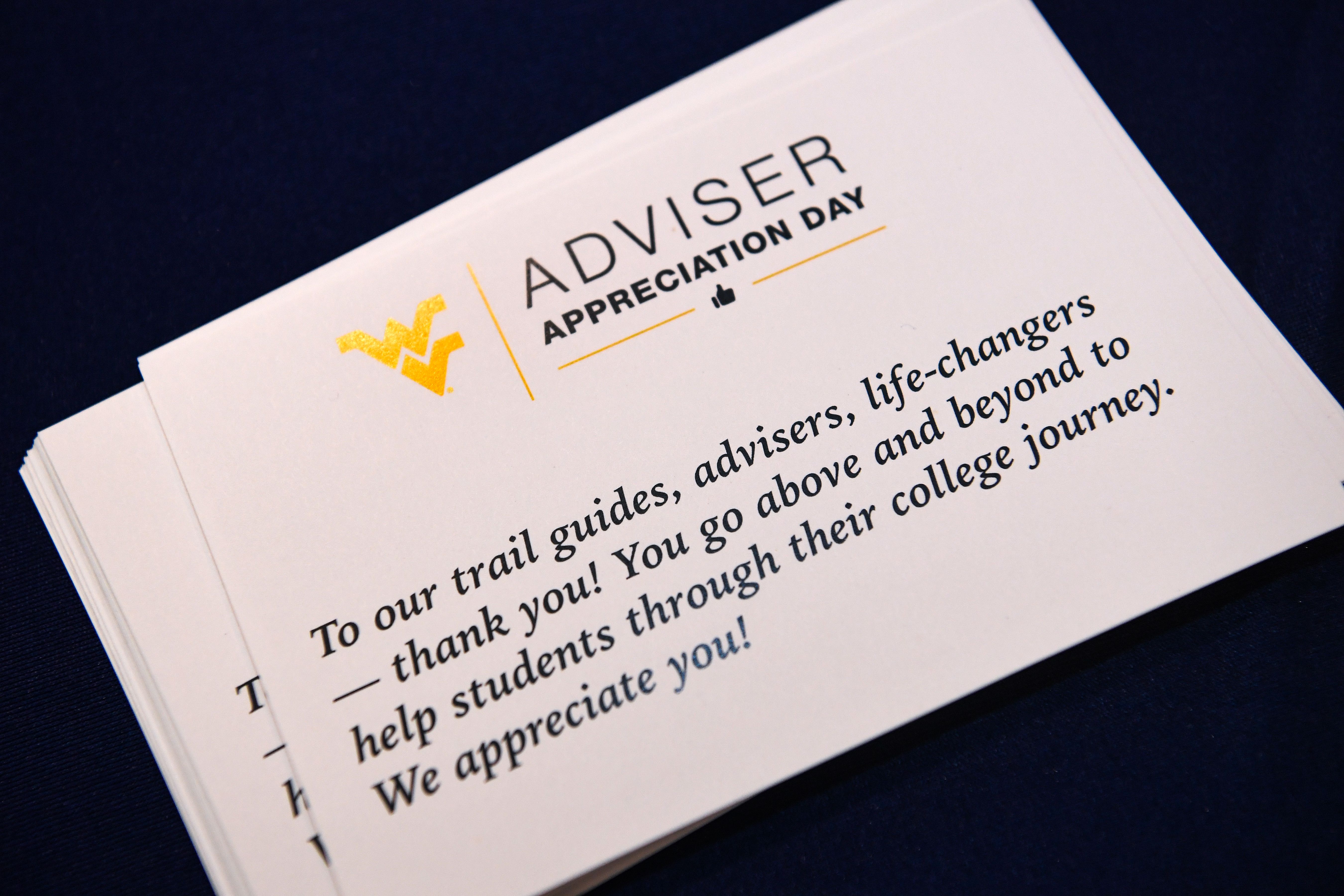 A thank you card sits on a table, its content reads praises to WVU advisrrs for adviser appreciation day.