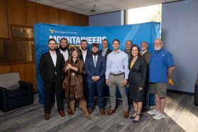A group photo of individuals who have previously been the WVU Mountaineer. 