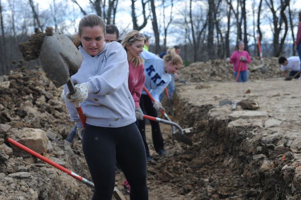 Sorority members digging on a Big Greek Day of Service project