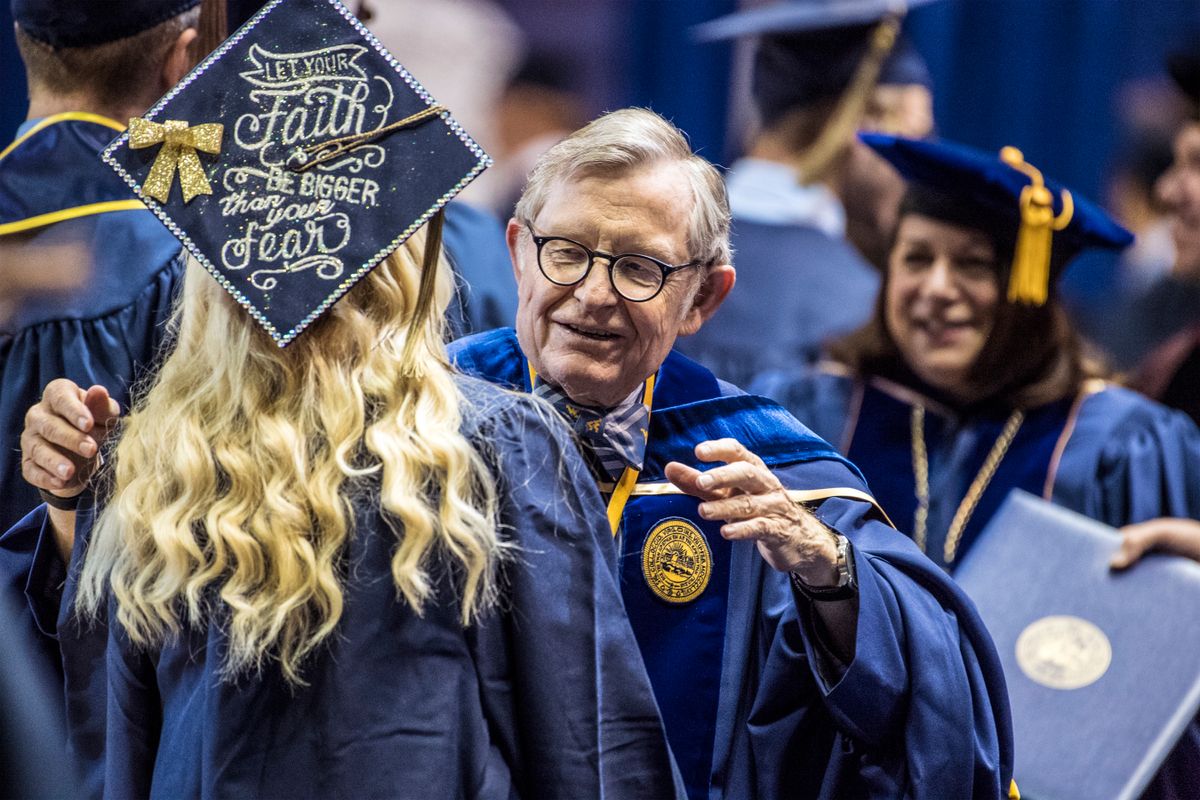 WVU President Gordon Gee greets students on stage during commencement ceremonies Dec. 15, 2017.