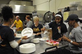 students working in soup kitchen