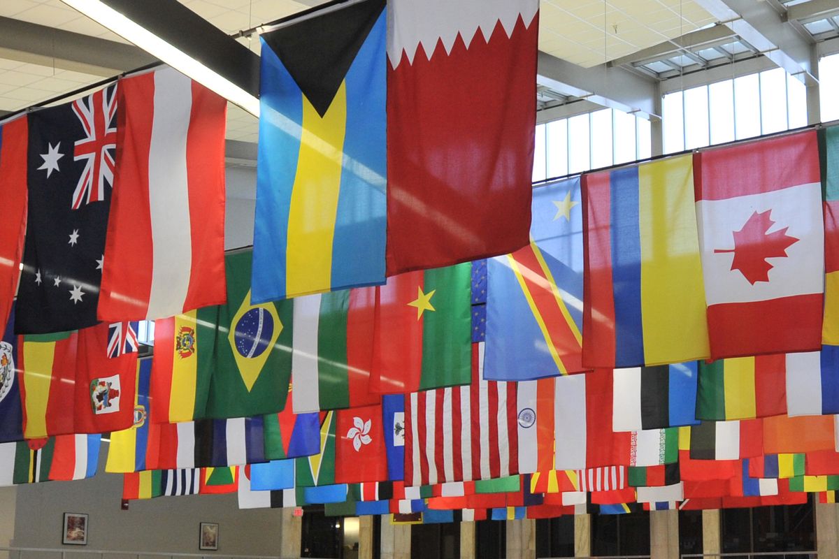 various flags hanging from a ceiling