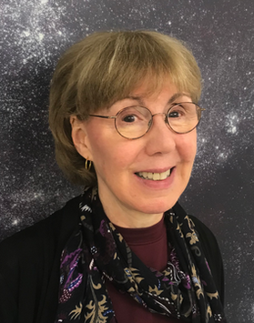 Headshot of WVU employee Joan Centrella. She is pictured against a starry, black and white background. She is wearing a black sweater and maroon blouse with a black and multi colored scarf around her neck. She has short blond hair and is wearing glasses. 