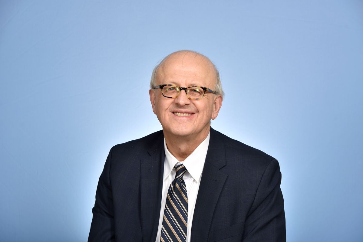 photo of man in glasses and suit and tie