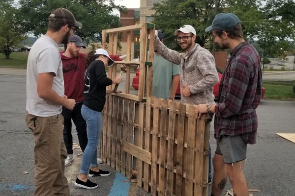 Men and women build a frame for landscaping