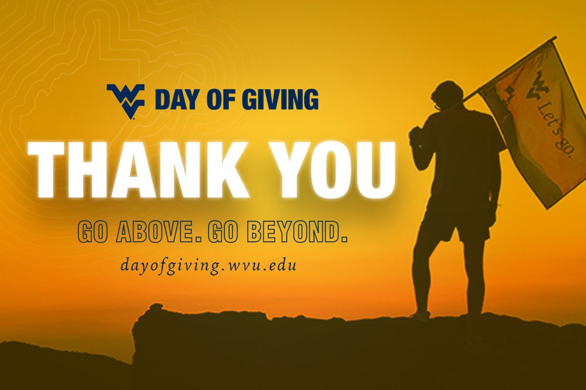 This is a gold graphic that says Day of Giving, Thank You. A person on the right stands on a mountain while holding a flag.