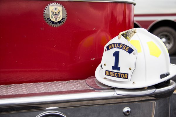 Firefighter hat on the edge of a fire truck.
