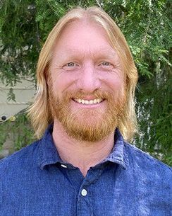 smiling man with blond hair, beard