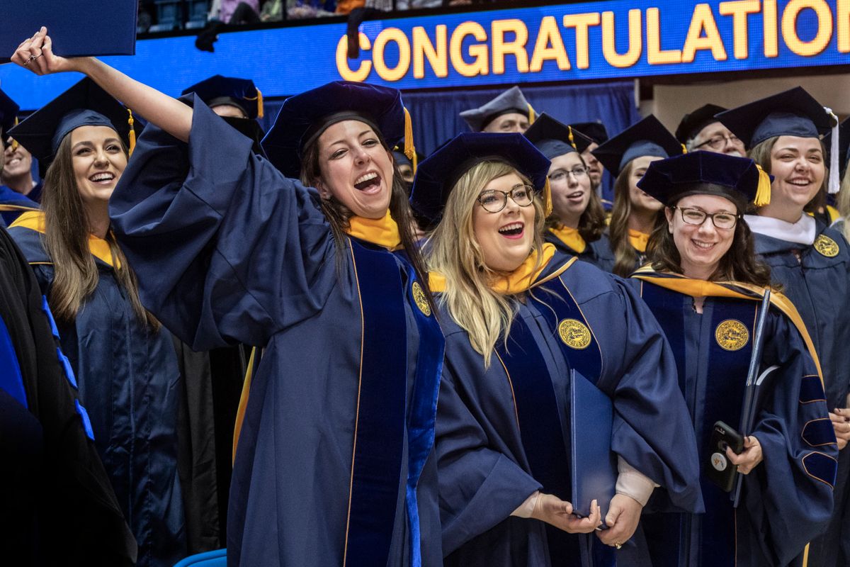 graduates in blue robes celebrate