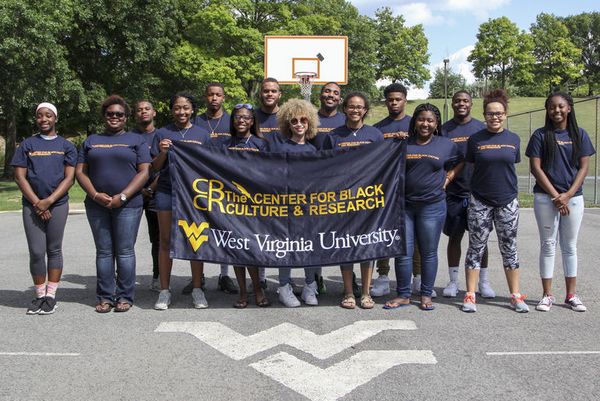 Members of WVU Academic STAR program hold a banner which reads 
