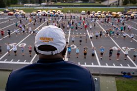 The director of the Mountaineer Marching Band surveys the band practice field.