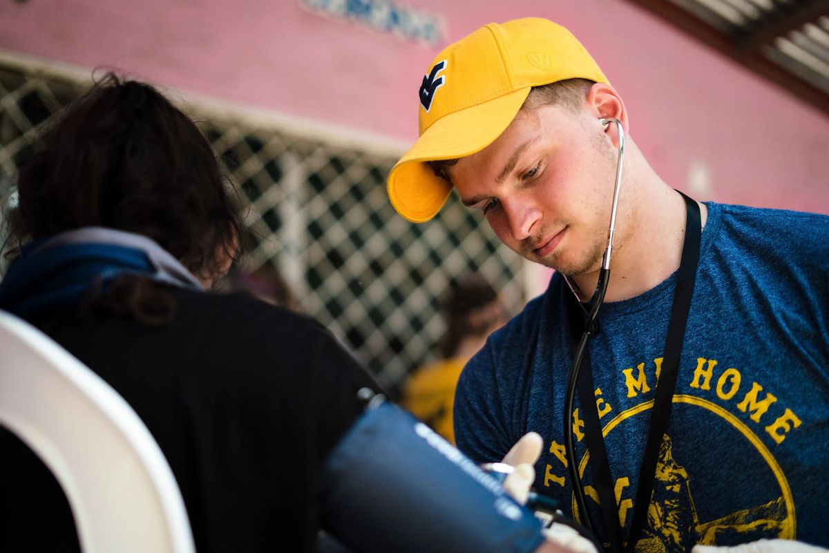 WVU student provides care to a person in Nicaragua as part of the Global Brigade