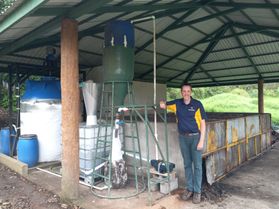 WVU Professor shown here looking at wastewater equipment in Costa Rica. The equipment is under a pavilion. 