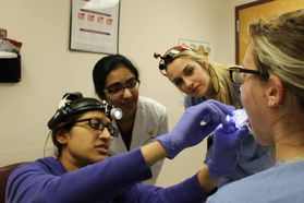 WVU School of Dentistry students examine a patient