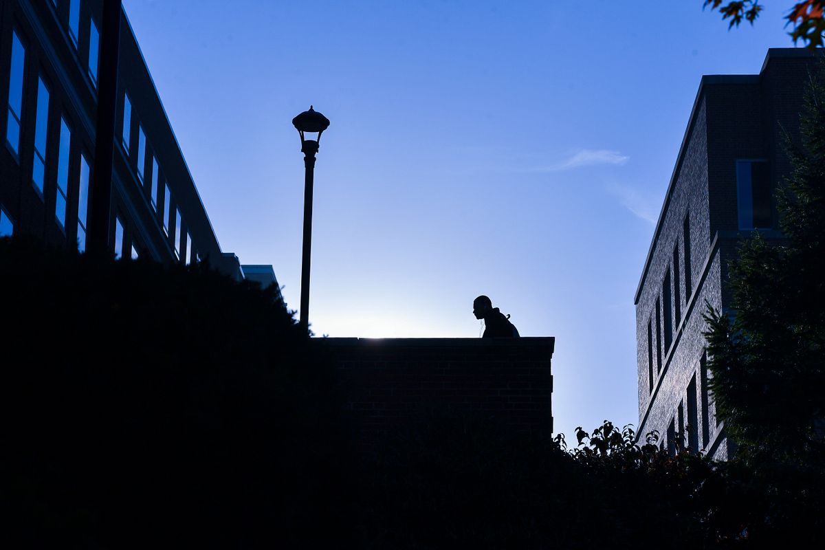 silhouette of man walking up steps