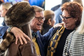 President Gordon Gee is in the middle of this photo. He has his right arm around Mary Roush, the Mountaineer Mascot, and his left arm around Autumn Cypres, dean of the College of Applied Human Sciences.