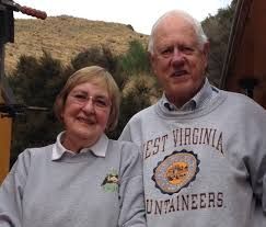 older woman and man wearing matching sweatshirts