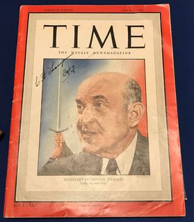 photo of TIME magazine cover with red border and older man in black suit 
