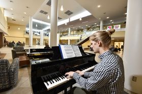 blonde man at piano in open space