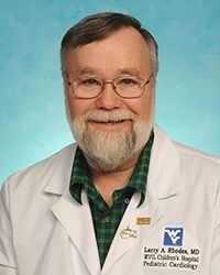 smiling man with beard and glasses in white coat