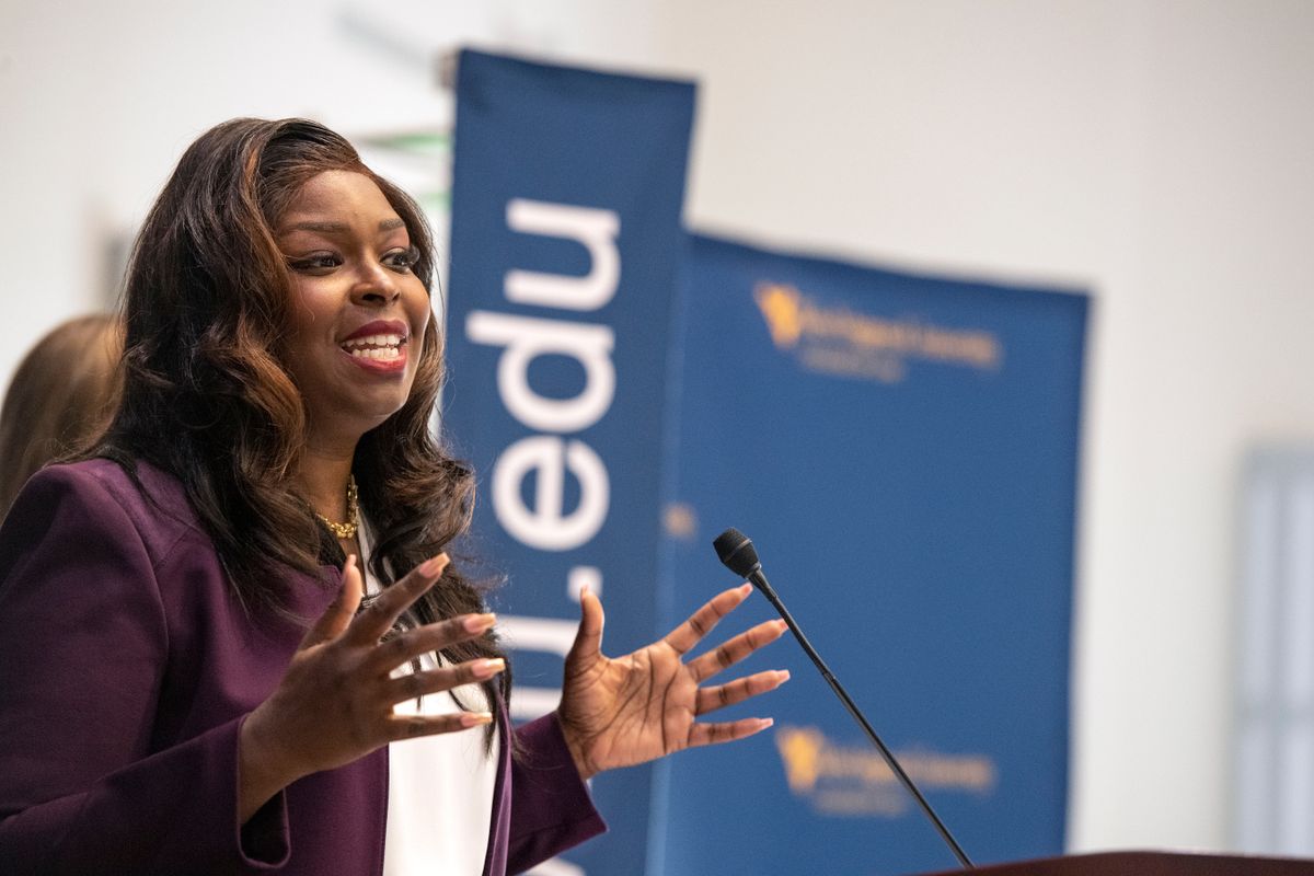 Black woman speaks at a podium