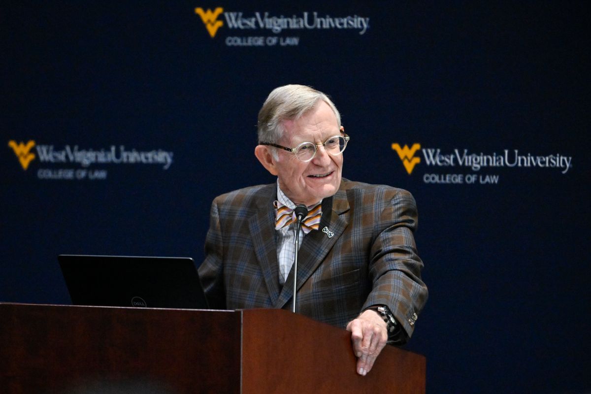 WVU President Gordon Gee gives a state of the university speech. He is standing at a podium and wearing a suit with a bowtie. 