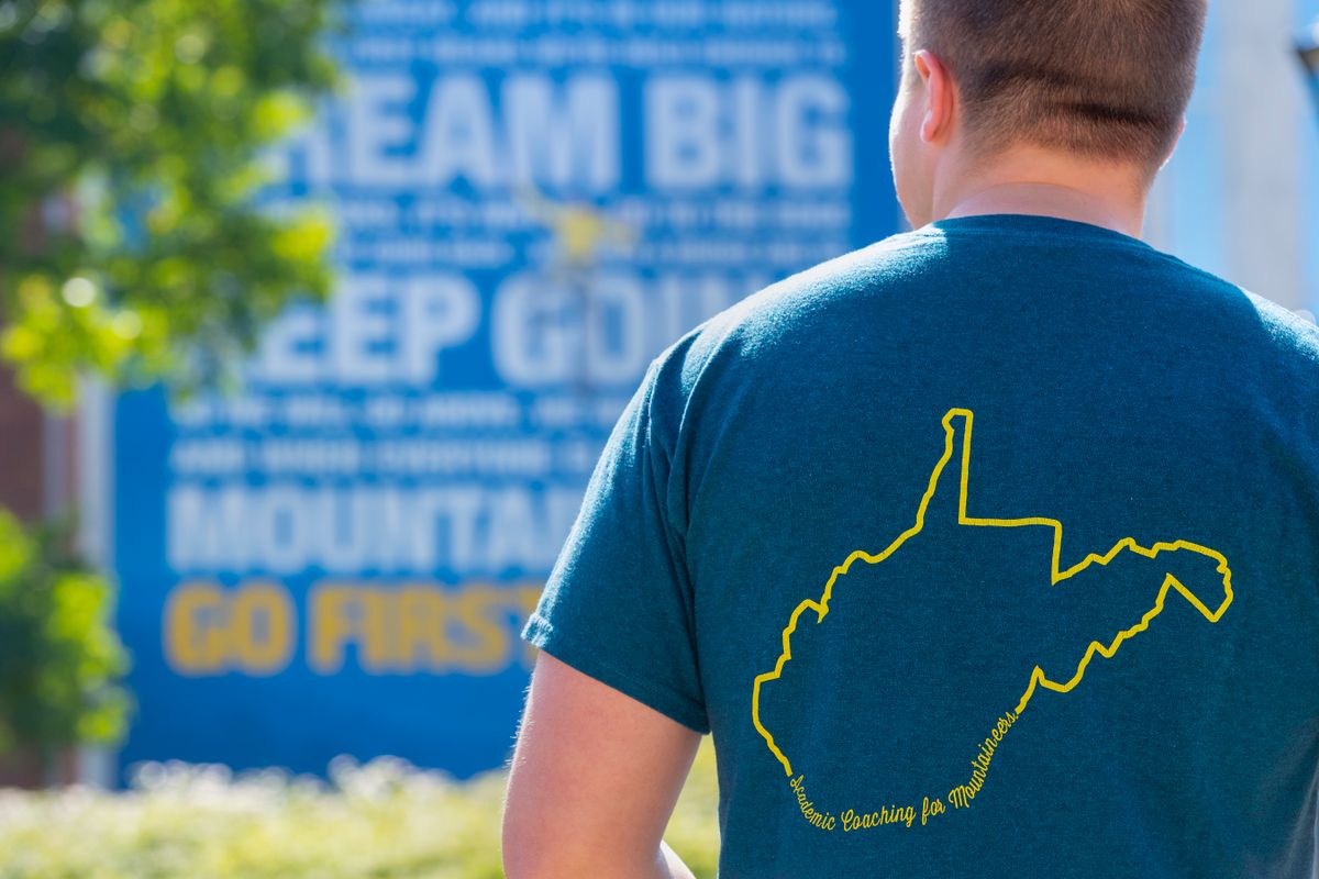 man wearing t-shirt with outline of West Virginia on the back