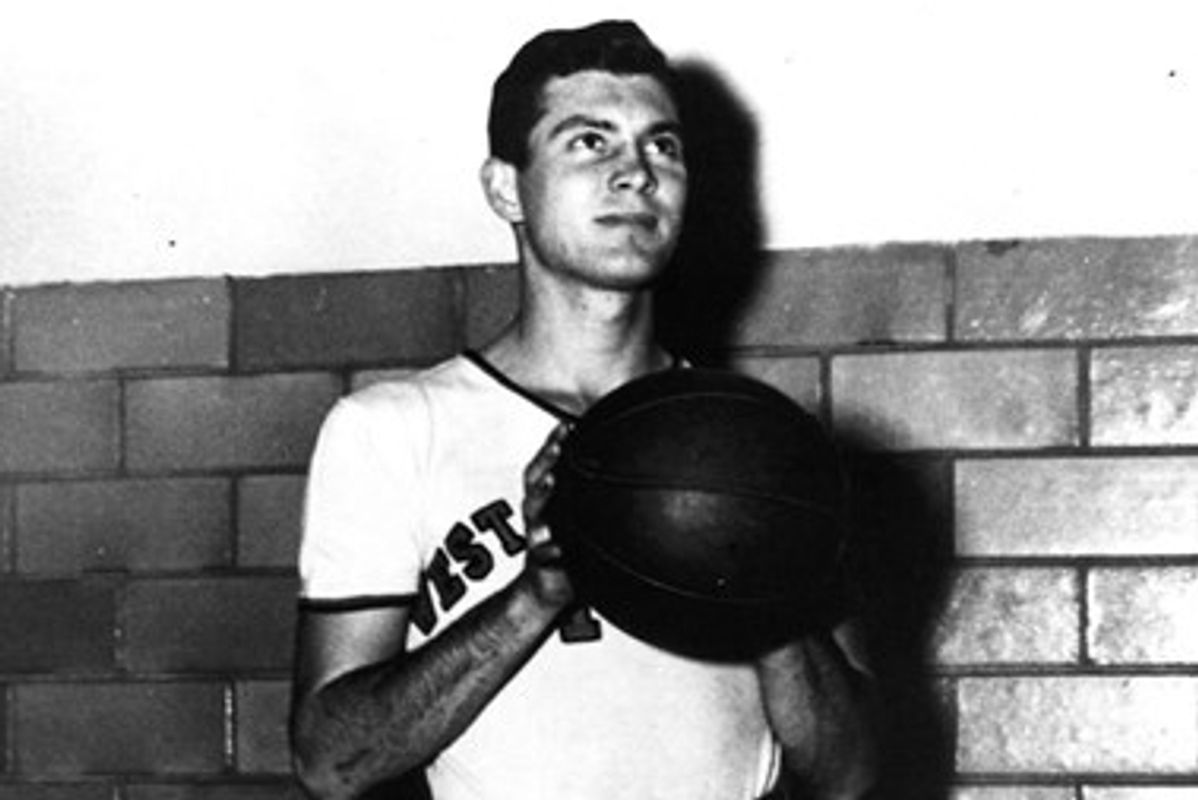 man with basketball looks up