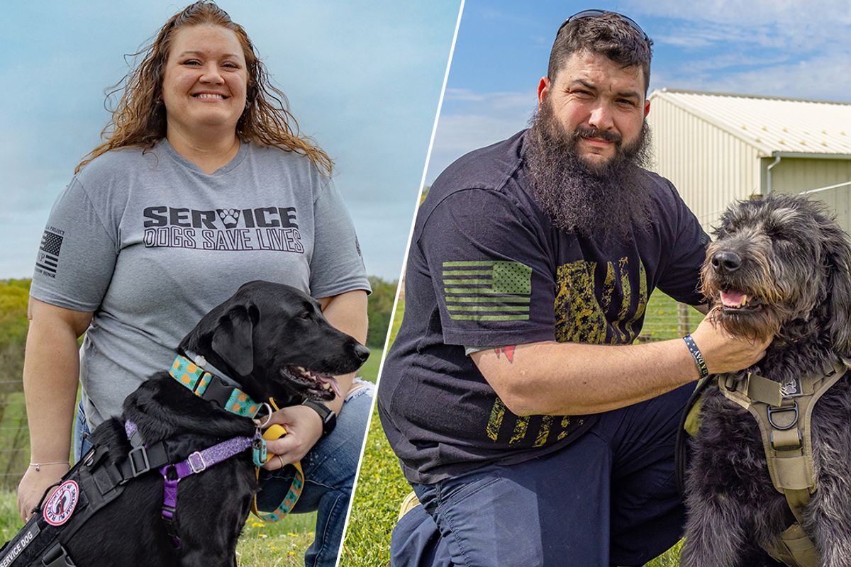 This is a double shot. On the left side a woman with blond hair wearing a gray shirt with the words 'Service dogs save lives' kneels beside a black dog. On the right site, a man with a beard wearing a dark shirt holds the tan collar of a gray dog
