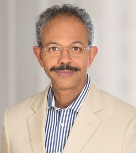 smiling man with mustache, glasses