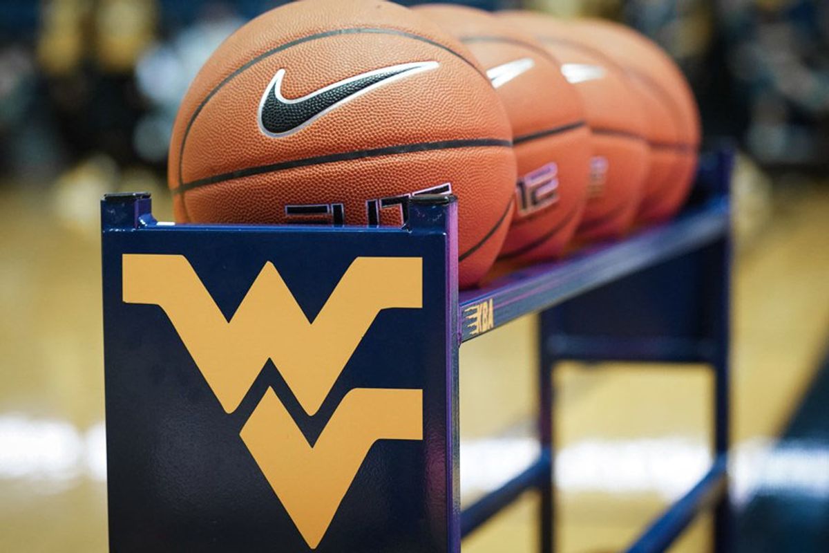 Basketballs on a stand with a WVU logo
