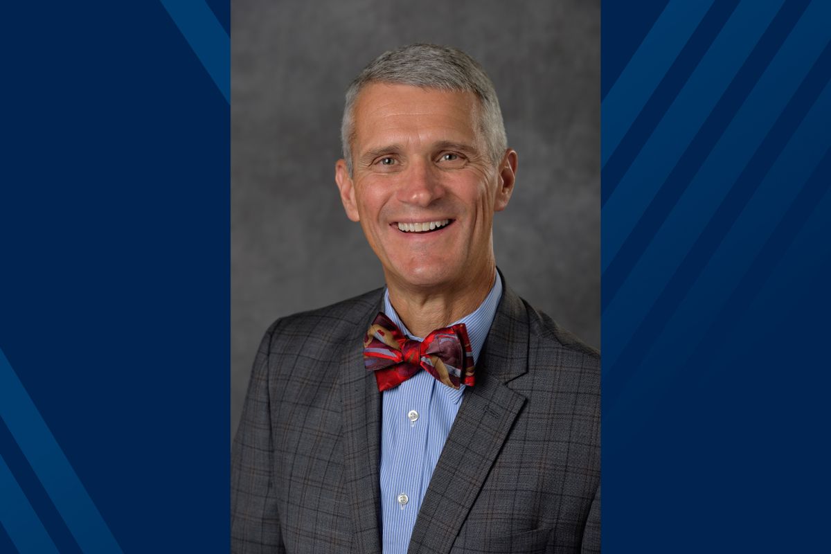 man with grey hair in bow tie and suit