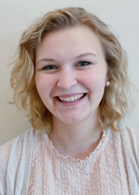 smiling young woman with short blondfe hair 