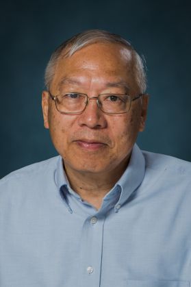 photo of man in button down blue shirt, glasses