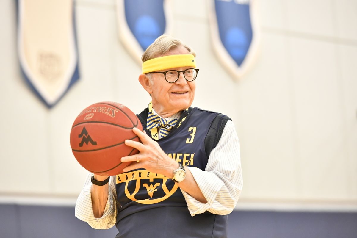 President E. Gordon Gee holding a basketball.