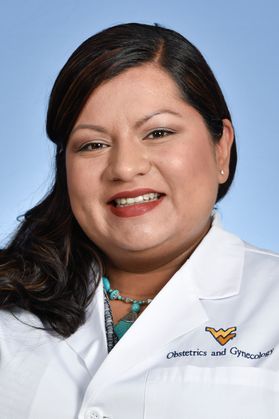 Woman with dark hair wearing white coat with flying WV/Obstetrics and Gynecology