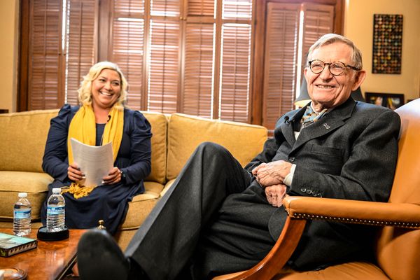 WVU President Gordon Gee (left) and Whitney Godwin (right) sit on a couch in an office smiling