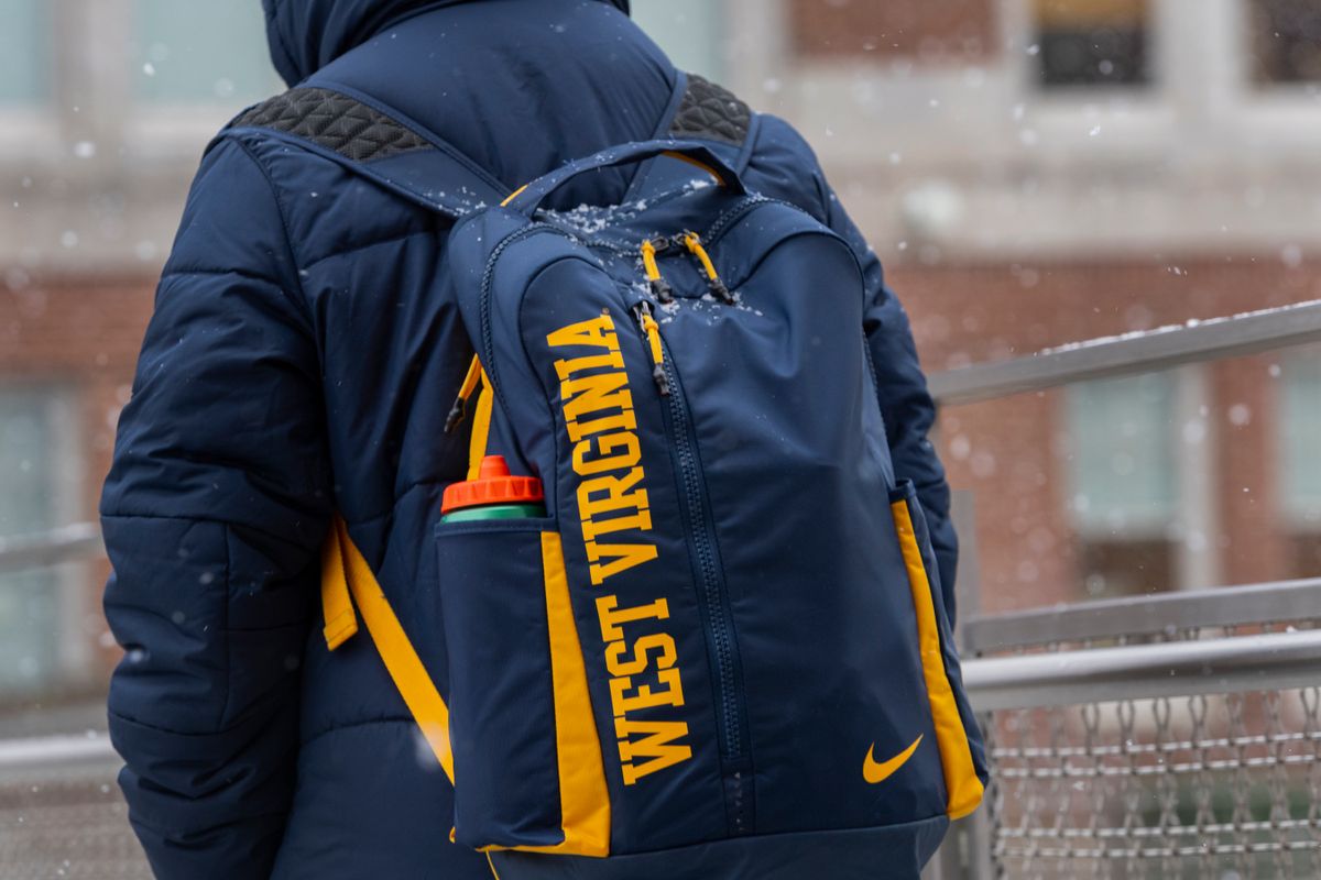 WVU student wears a backpack on the way to class in the snow.