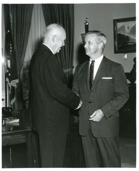 Photo in black and white of two men meeting.