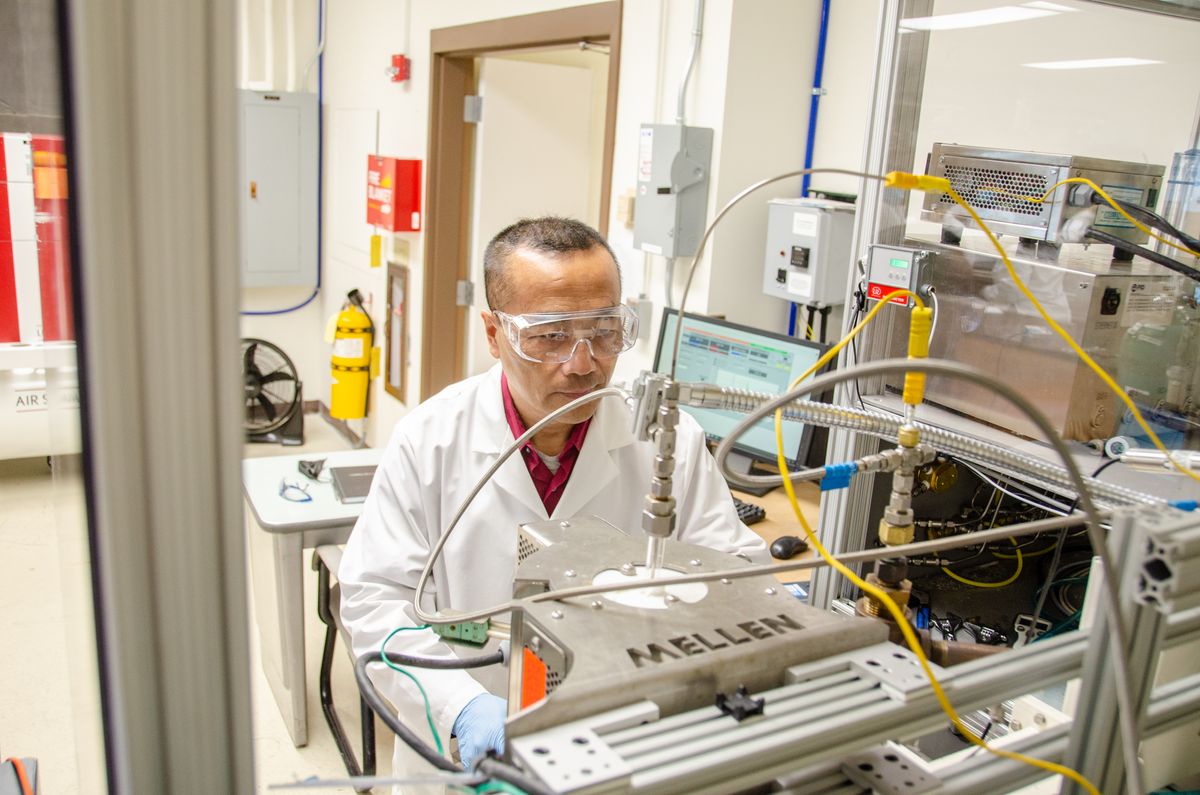 Chemical engineer John Hu is pictured operating a microwave reactor in his WVU lab.