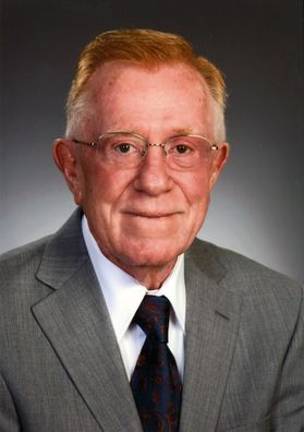 older man in suit and tie, headshot