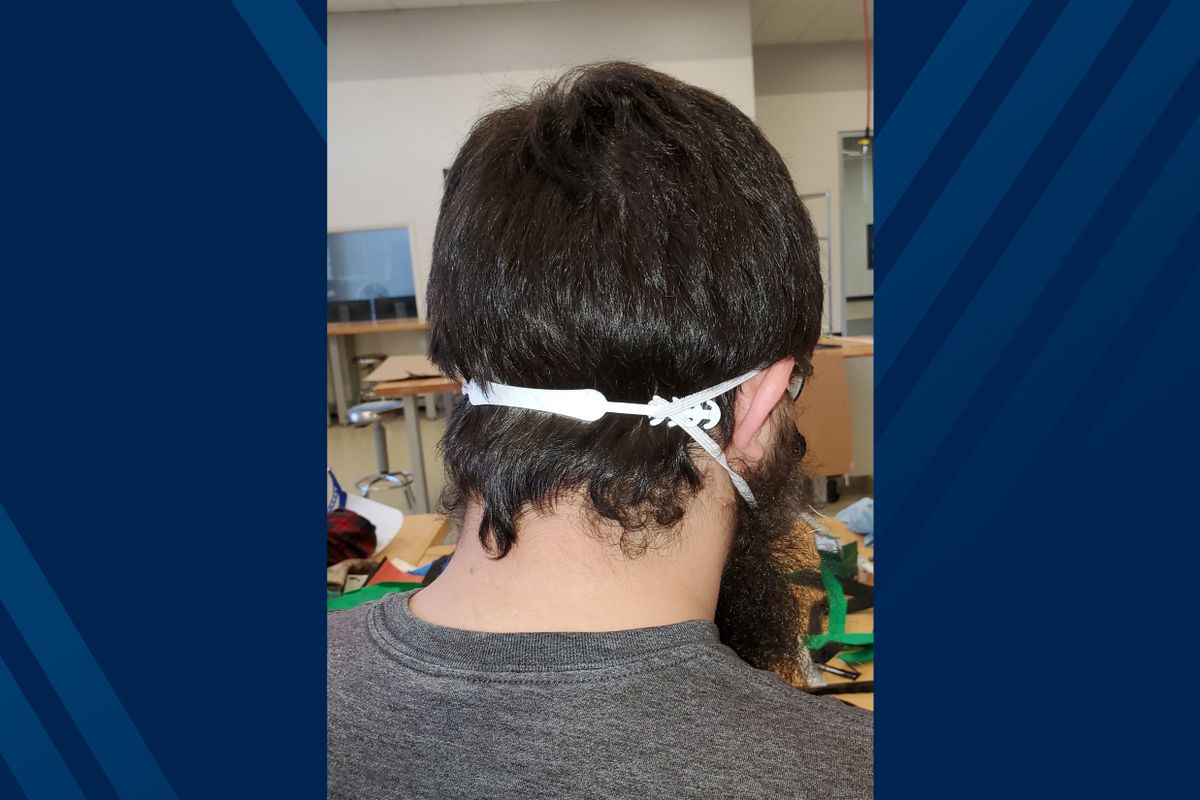 back of man's head showing small elastic and plastic piece