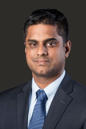 Portrait photo of young brown man in suit