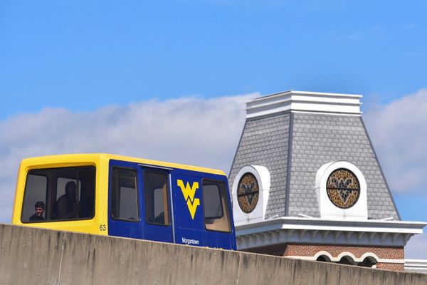 PRT car passing by the WVU Alumni Center tower