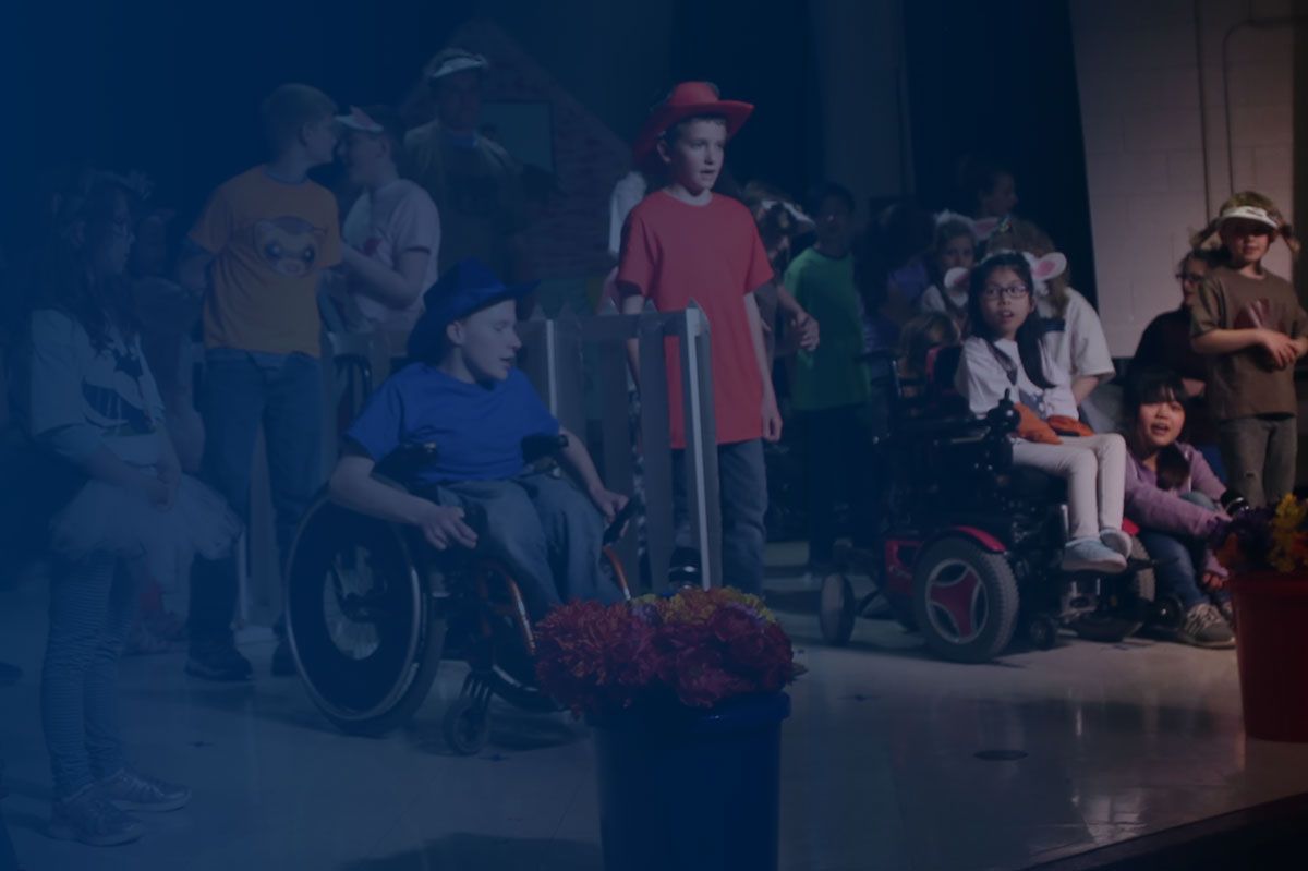 Dim photo of children in wheelchairs and with crutches