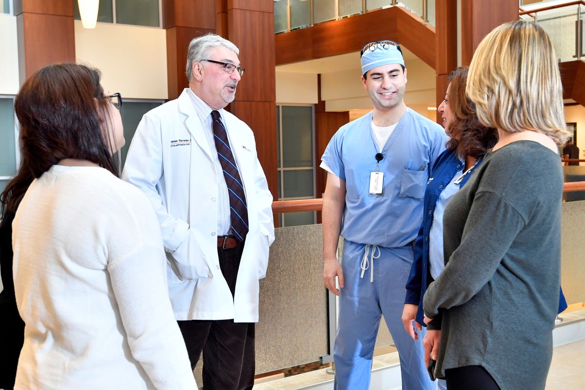 WVU School of Medicine resident Habib Zalzal (third from right) talks with Hassan Ramadan, chair of WVU's Department of Otolaryngology, Head and Neck Surgery (fourth from right), and other members of his research team