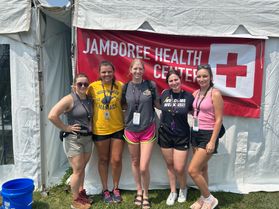 Five WVU nursing student volunteers pose together in front of the Health Center tent at the Boy Scouts of America National Jamboree. 