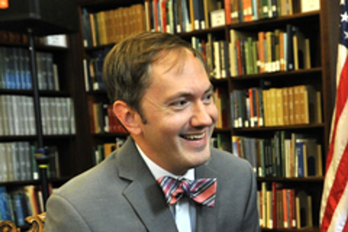 Environmental photo of R. Scott Crichlow in front of bookshelves